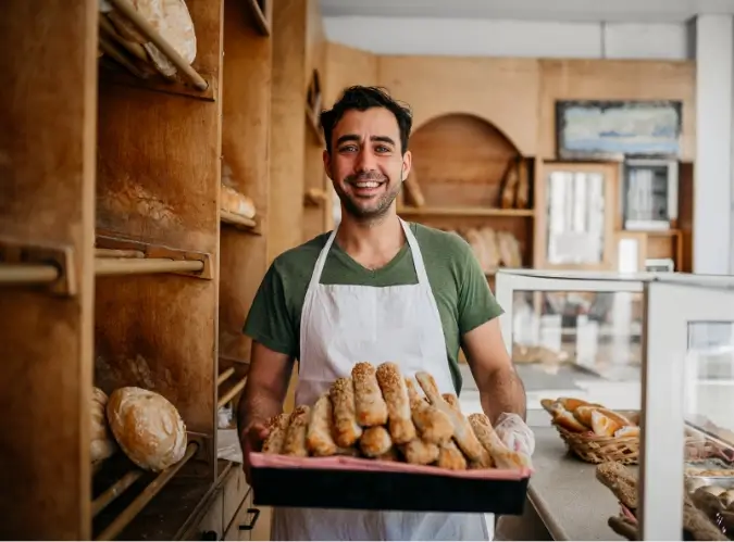 Man carrying loaves of bread